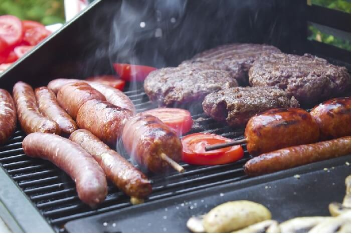 BBQ Menus BBQ grill with sausages, burgers and tomatoes